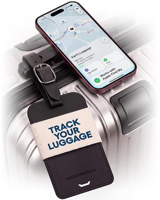 Spotminders litchi-grain leather Find My luggage tag on a suitcase handle